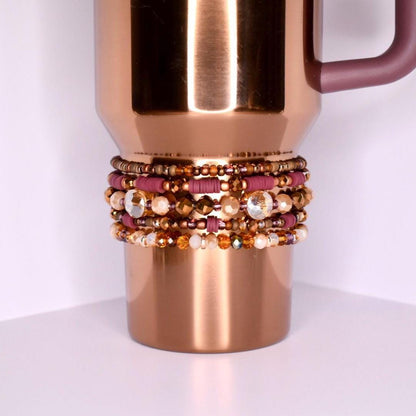 Neutral-toned tumbler bracelets for Stanley-style cups with shimmering rose gold, amber, and mauve beads in a coordinated boho stack of 5