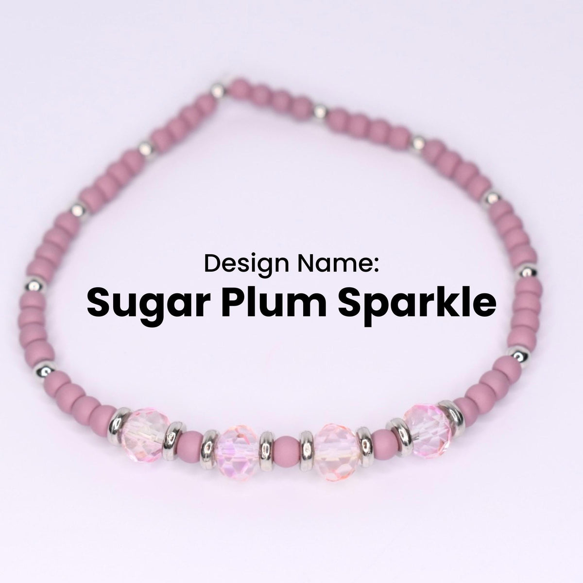 A Sugar Plum Sparkle bracelet. The bracelet features small, round, matte mauve beads interspersed with silver-colored metal beads. The bracelet also has larger, faceted, clear beads with a pinkish hue, adding a touch of sparkle. The design name is displayed in black text.