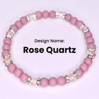 A pink Rose Quartz bracelet with alternating round beads and crystal-studded silver accents. The design name 'Rose Quartz' is displayed in bold black text against a white background. The bracelet is a stretch style.