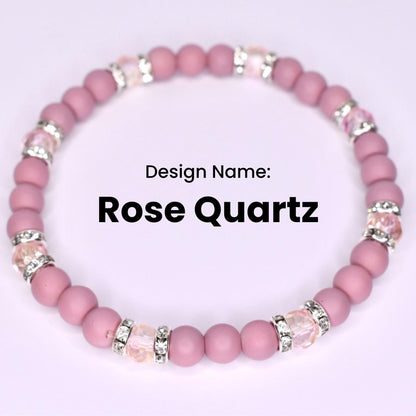 A pink Rose Quartz bracelet with alternating round beads and crystal-studded silver accents. The design name 'Rose Quartz' is displayed in bold black text against a white background. The bracelet is a stretch style.