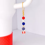 Tumbler handle charm bracelet hanging from white Stanley 40oz gold chain lobster clasp red white blue beads with metal patriotic sunglasses charm bracelet fits all handle cups adjustable jewelry gift for July 4 bbq host