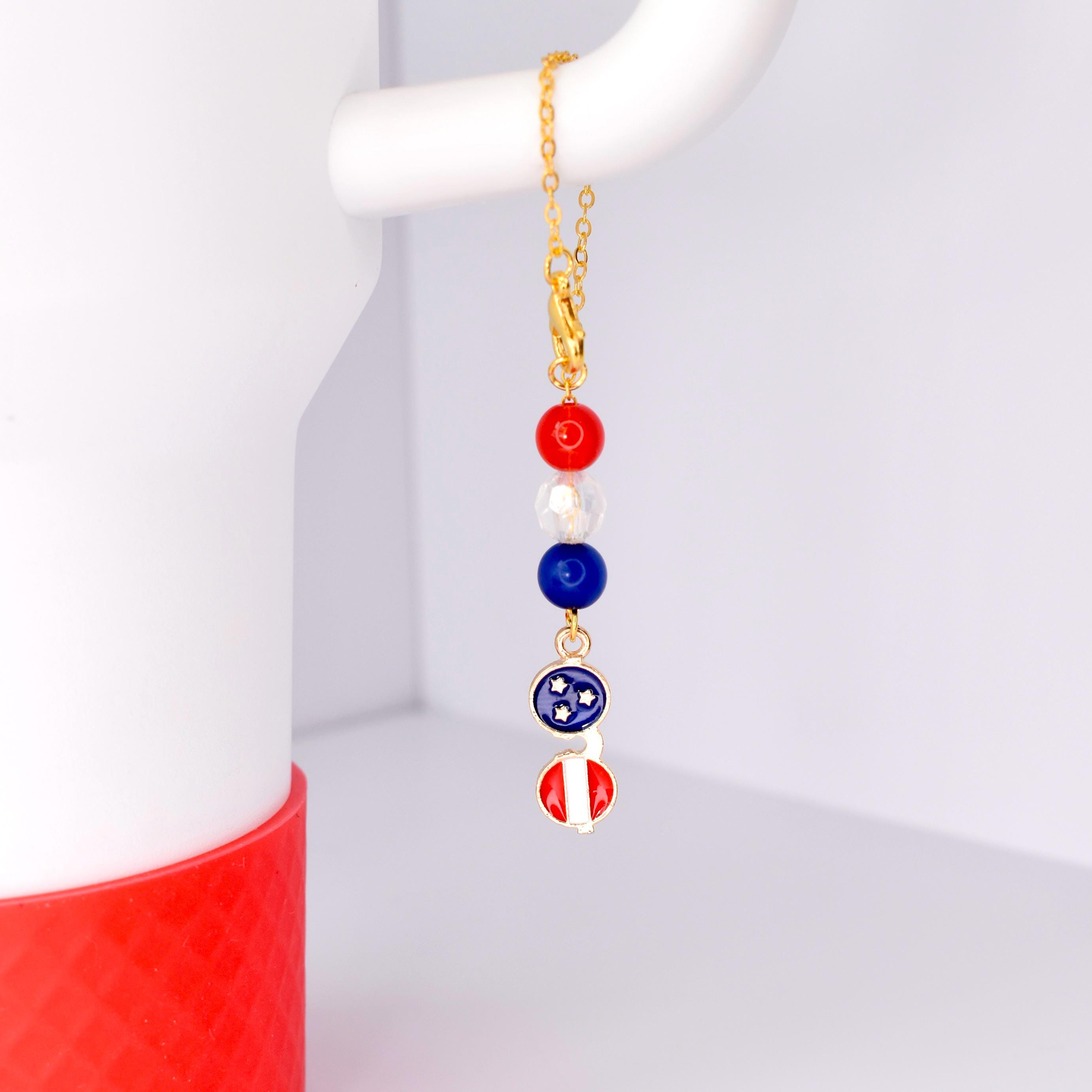 Tumbler handle charm bracelet hanging from white Stanley 40oz gold chain lobster clasp red white blue beads with metal patriotic sunglasses charm bracelet fits all handle cups adjustable jewelry gift for July 4 bbq host