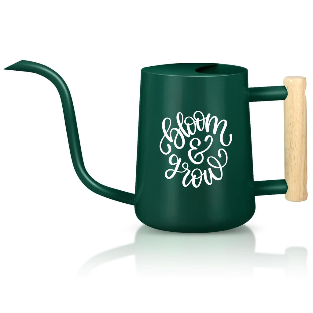 A dark green metal watering can with a long, curved spout and a wooden handle. The words "bloom & grow" are written in white script on the side. The watering can is designed for indoor or outdoor plant care.