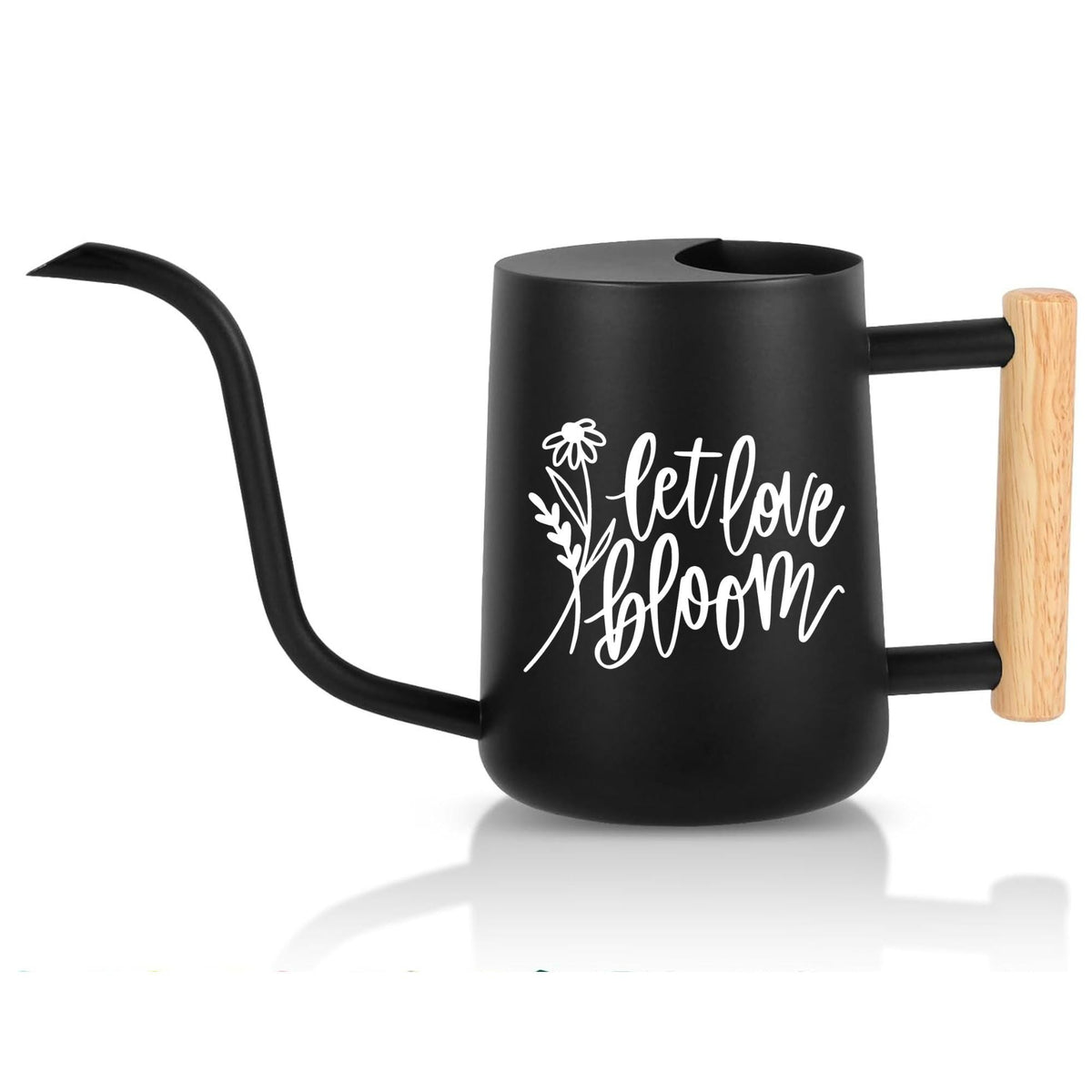 A black watering can with a long, curved spout and a wooden handle. The can has a rounded body and a flat top with a fill hole. White script on the side reads 'let love bloom' with a floral design. The handle is made of light-colored wood.