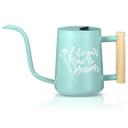 A light blue watering can with a long, curved spout and a wooden handle. The can has a cylindrical body with a rounded base and a handle on the side. White text on the can reads 'it's your time to blossom' with a floral design. The watering can is designed for gardening.