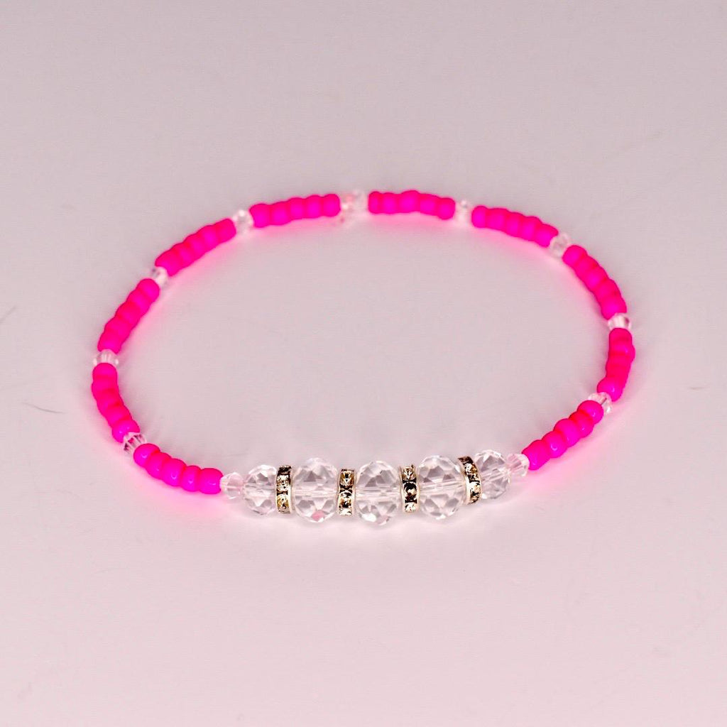 Tropical tumbler bracelet set of 5 with monstera leaves, sparkly green beads, and pink hibiscus flowers—perfect for beach vacations and poolside flair.