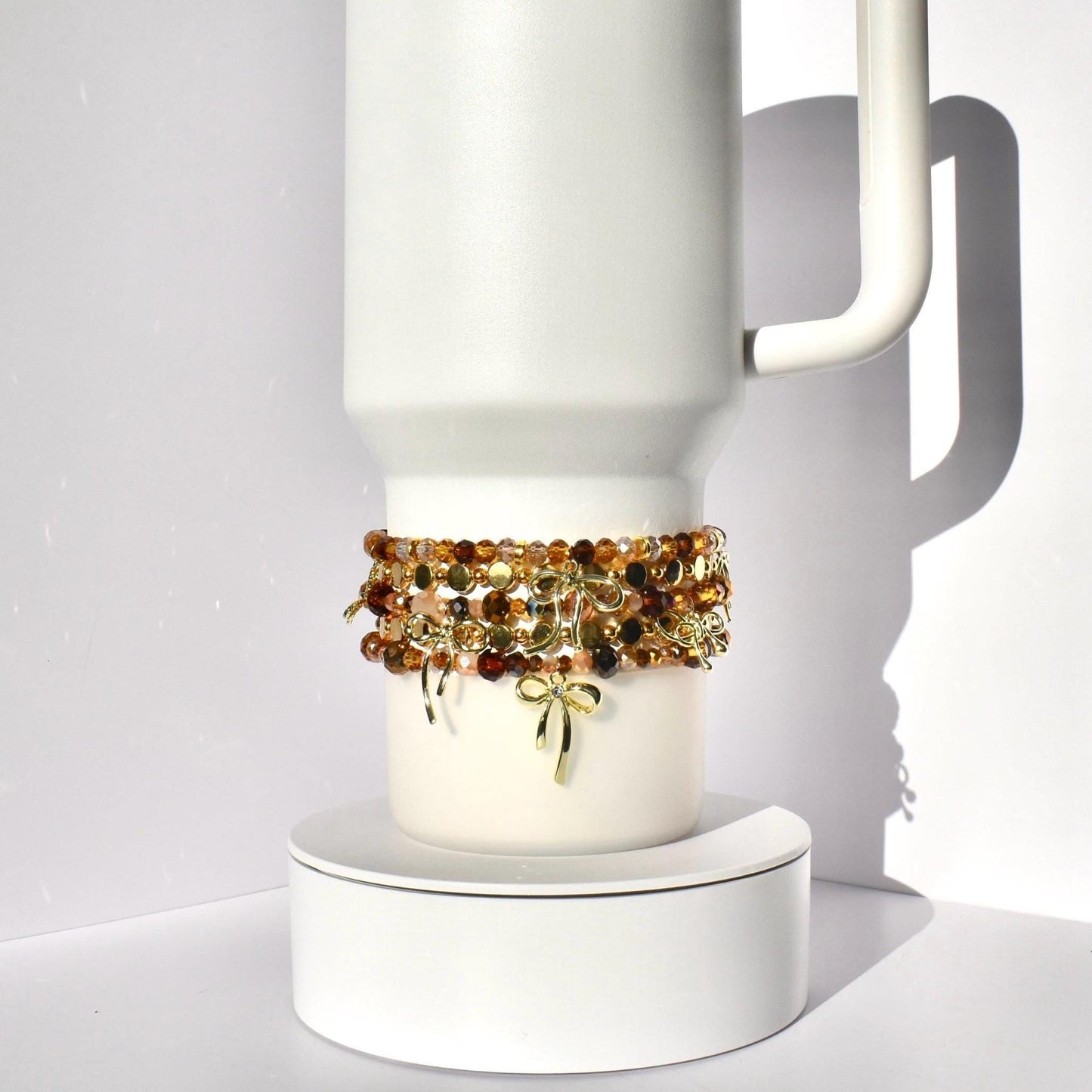 Tumbler Bracelet Collection Cup Holder Jewelry Glass Bead Set Amber Brown Gold Color Combination Decorative Bow Charm Accent Elastic Band Design Tumbler Accessories Perfect Gift Idea Stretchy Jewelry Collection Custom Drink Holder Style