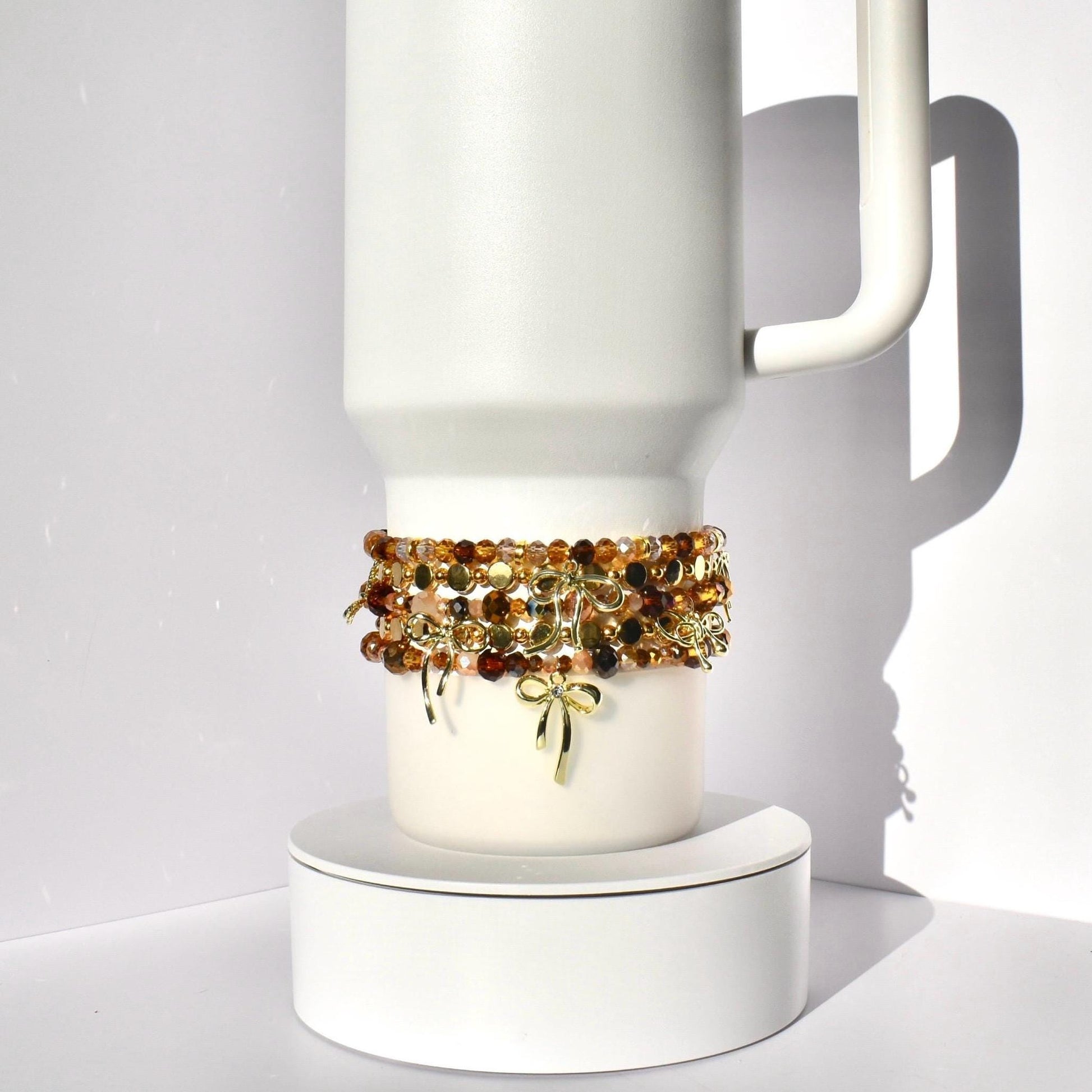 Tumbler Bracelet Collection Cup Holder Jewelry Glass Bead Set Amber Brown Gold Color Combination Decorative Bow Charm Accent Elastic Band Design Tumbler Accessories Perfect Gift Idea Stretchy Jewelry Collection Custom Drink Holder Style