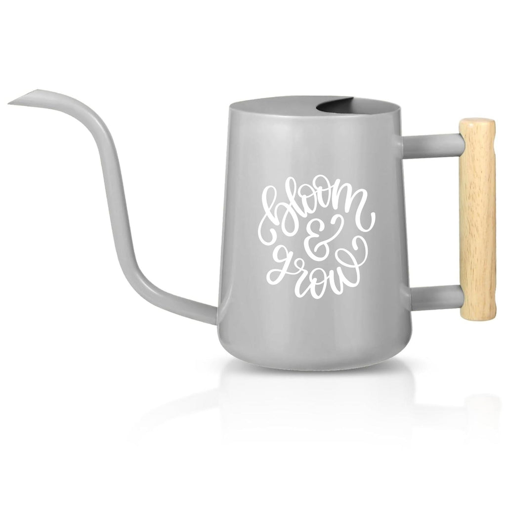 A gray watering can with a long, curved spout and a wooden handle. The words "bloom & grow" are written in white script on the side. The watering can is designed for indoor or outdoor plant care.