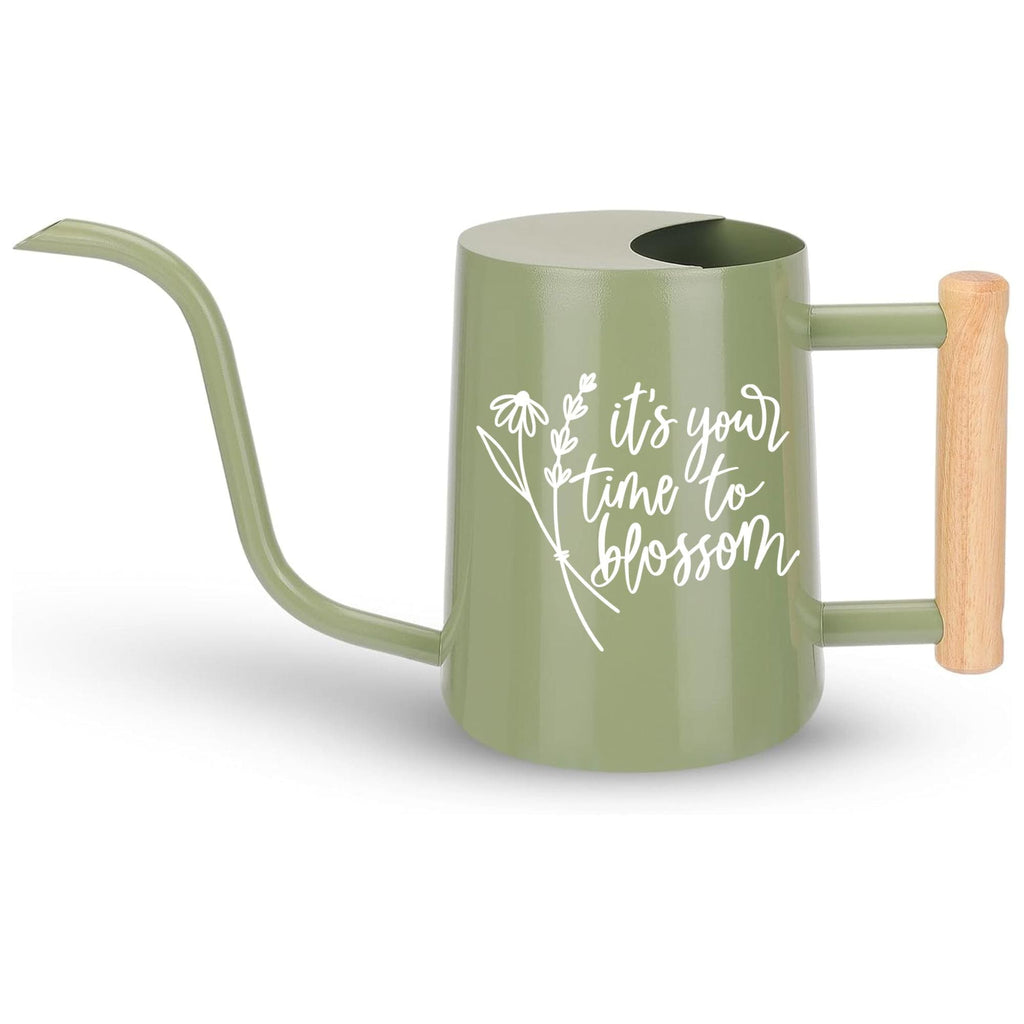 A sage green watering can with a long, curved spout and a wooden handle. The watering can features the phrase 'it's your time to blossom' in white script, accompanied by a floral design. The handle is made of light-colored wood.