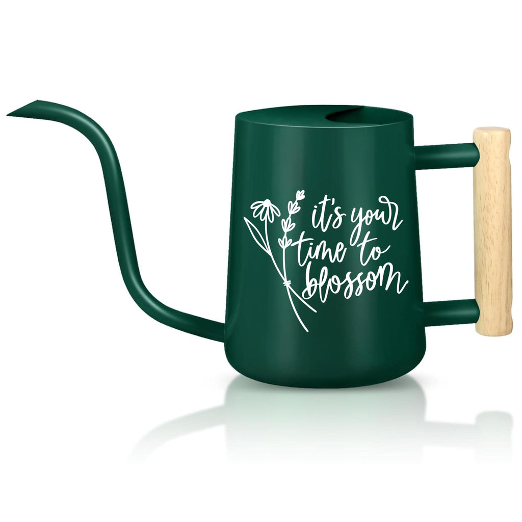 A dark green watering can with a long, curved spout and a wooden handle. The watering can features white text that reads 'it's your time to blossom' with a floral design. The handle is a light brown color. The watering can is designed for gardening and plant care.