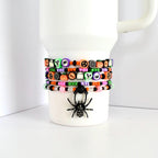Set of 5 beaded Halloween bracelets for tumbler cups with festive themed charms—skulls, jack-o’-lanterns, spiderwebs, ghosts, and rhinestone spider charm.