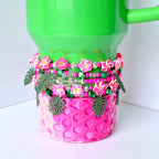 Stack of 5 handmade tumbler bracelets featuring pink flowers, sparkly green beads, pearl accents, and green monstera leaves—perfect tropical tumbler decor for summer vibes.
