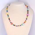 A colorful rainbow beaded necklace with flower accent beads.