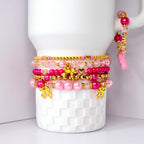 Pink tumbler charm bracelet with tiny pink tumbler charm, gold bows, pearls, and sparkling pink beads fun girly cup accessory.