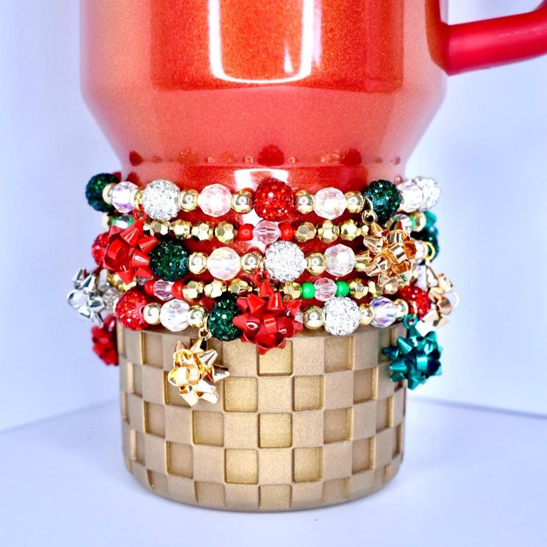 Handcrafted Holiday Bracelets Christmas Bracelet Stack Tumbler Accessory Collection Red Green Beaded Design Bow Charm Detail Sparkle Elastic Band Festive Wrist Decoration Cup Enhancement Set Holiday Gift Idea Seasonal Jewelry Piece