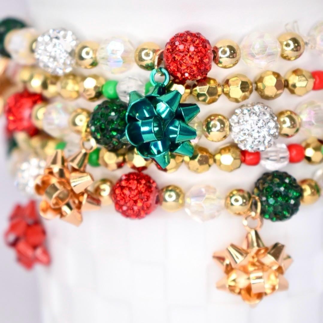 Christmas tumbler wrap bracelet set – handmade beaded holiday bracelet with festive bow charms and sparkling red, green, and gold beads.