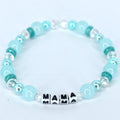 Mama bracelet with green and white pearl beads, crystal accents, and letter beads spelling MAMA handmade mom jewelry gift.