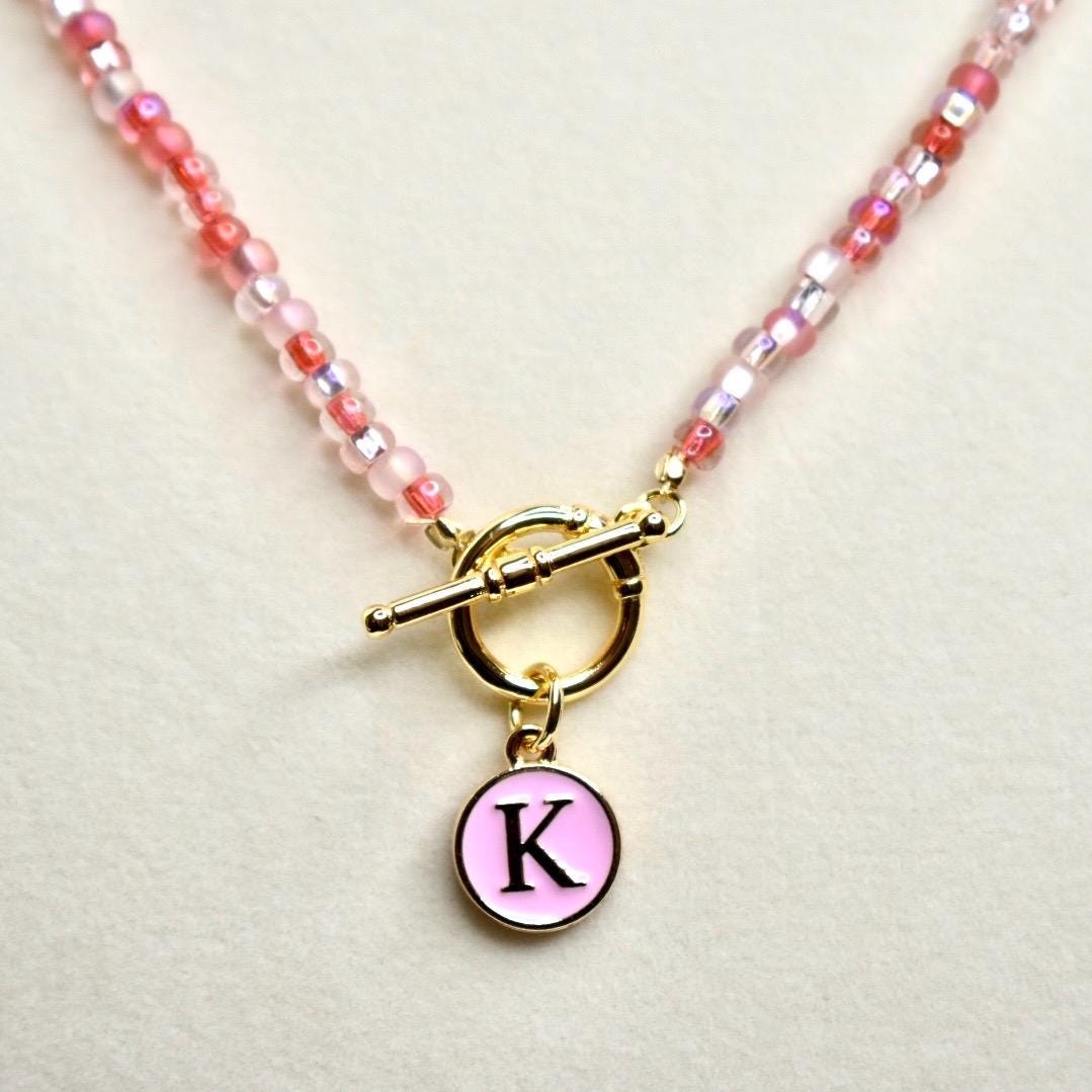 Beaded Necklace Jewelry Handmade Glass Bead Strand Red Pink White Shades Gold Tone Toggle Clasp Round Initial Pendant Personalized Letter Charm Jewelry Fashion Accessory Perfect for Gifting