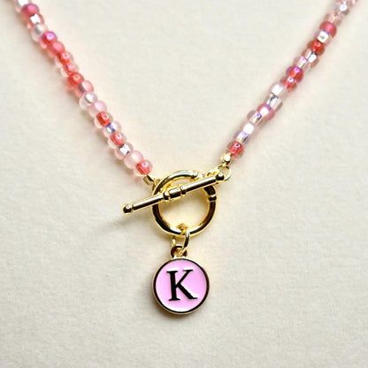 Beaded Necklace Jewelry Handmade Glass Bead Strand Red Pink White Shades Gold Tone Toggle Clasp Round Initial Pendant Personalized Letter Charm Jewelry Fashion Accessory Perfect for Gifting