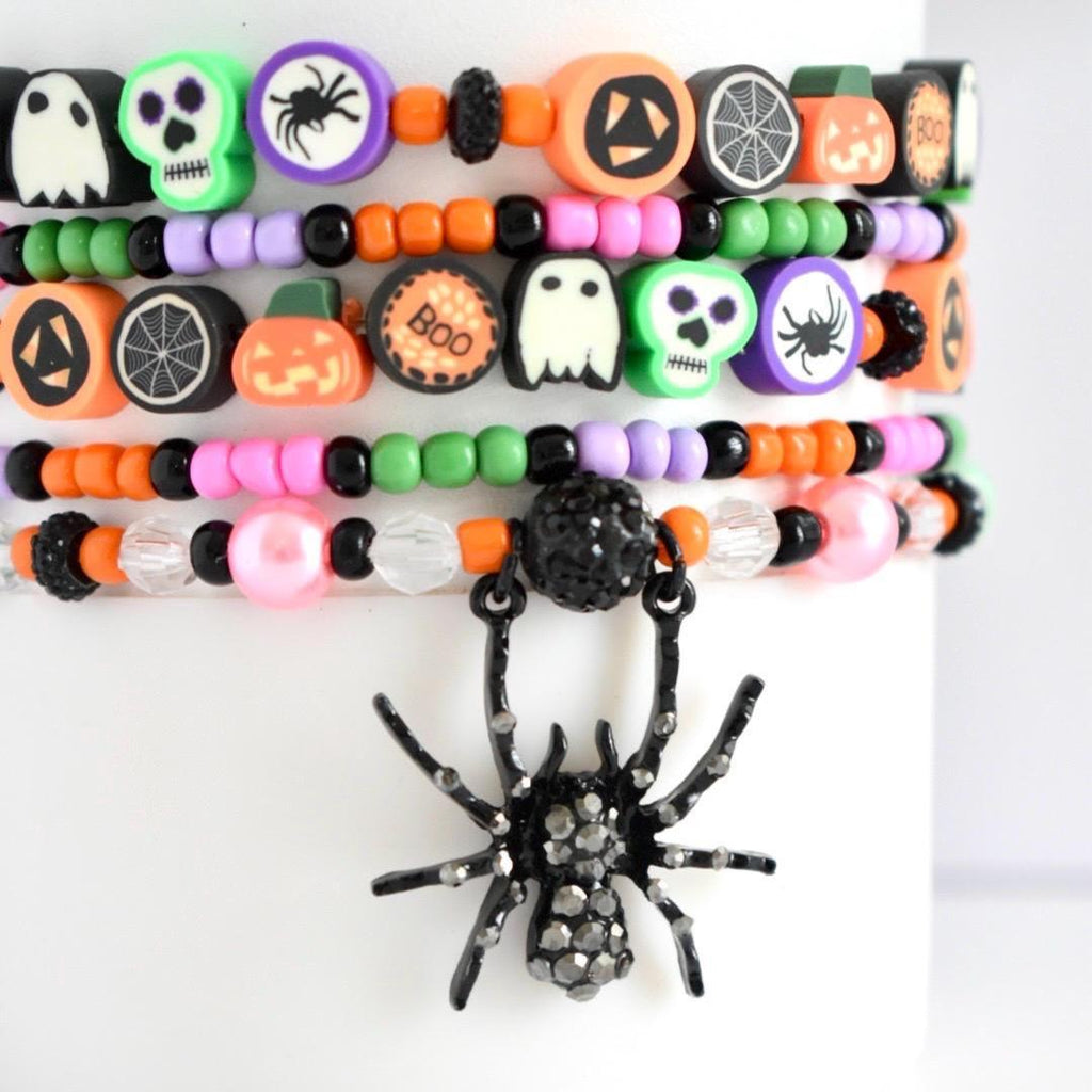 Cute Halloween stackable bracelets for Stanley with themed polymer clay beads—black spider, purple skull, boo, ghost, pumpkin, and bright bead colors.