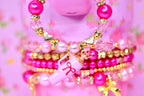 Pink and gold tumbler bracelet set featuring gold bow charms pearls and faceted crystal beads cute girly tumbler accessory.