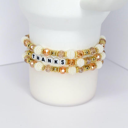 Fall tumbler bracelet with gold, white, and crystal beads – ‘Give Thanks’ beaded wrap for autumn drinkware and Thanksgiving gifts.