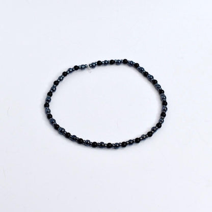 Beaded tumbler bracelet with spider, skeleton hand, and web charms – black and silver Halloween wrap bracelet for gothic drinkware decor.