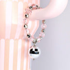 A pink beaded tumbler handle charm with silver accents and a small disco ball charm. The bracelet is made of clear pink beads and silver beads. The disco ball charm is silver and reflective.