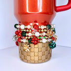 Holiday sparkle tumbler bracelet – red, green, and gold beads with glitter bow charms for Christmas party drinkware accessories.