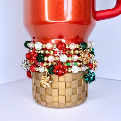 Holiday sparkle tumbler bracelet – red, green, and gold beads with glitter bow charms for Christmas party drinkware accessories.