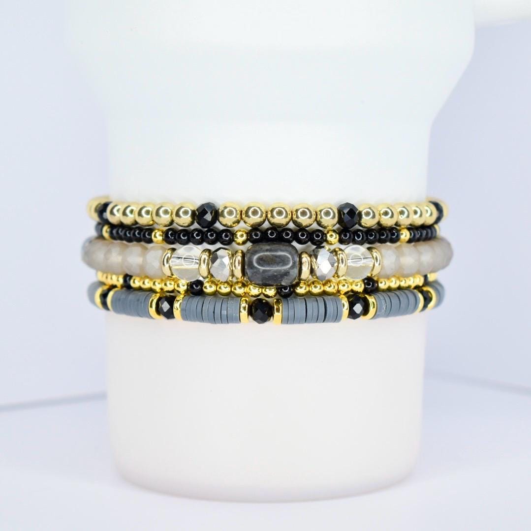 Classy tumbler bracelet wrap – black, gray, and gold beaded drink accessory for coffee lovers.