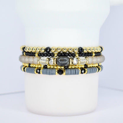 Classy tumbler bracelet wrap – black, gray, and gold beaded drink accessory for coffee lovers.