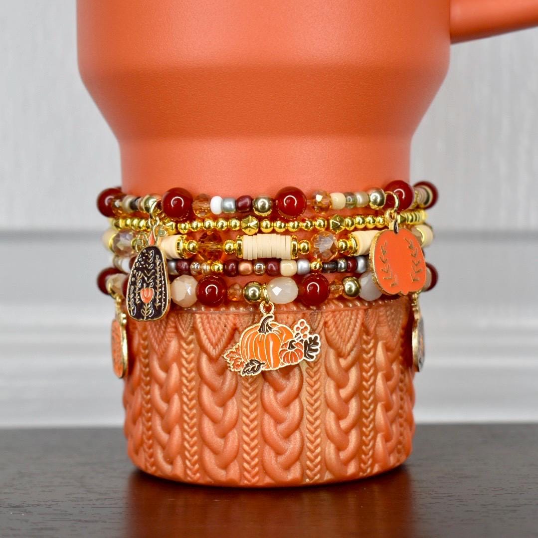 Fall drinkware bracelet - pumpkin charm wrap with red and gold beads for Thanksgiving and seasonal cup accessories.
