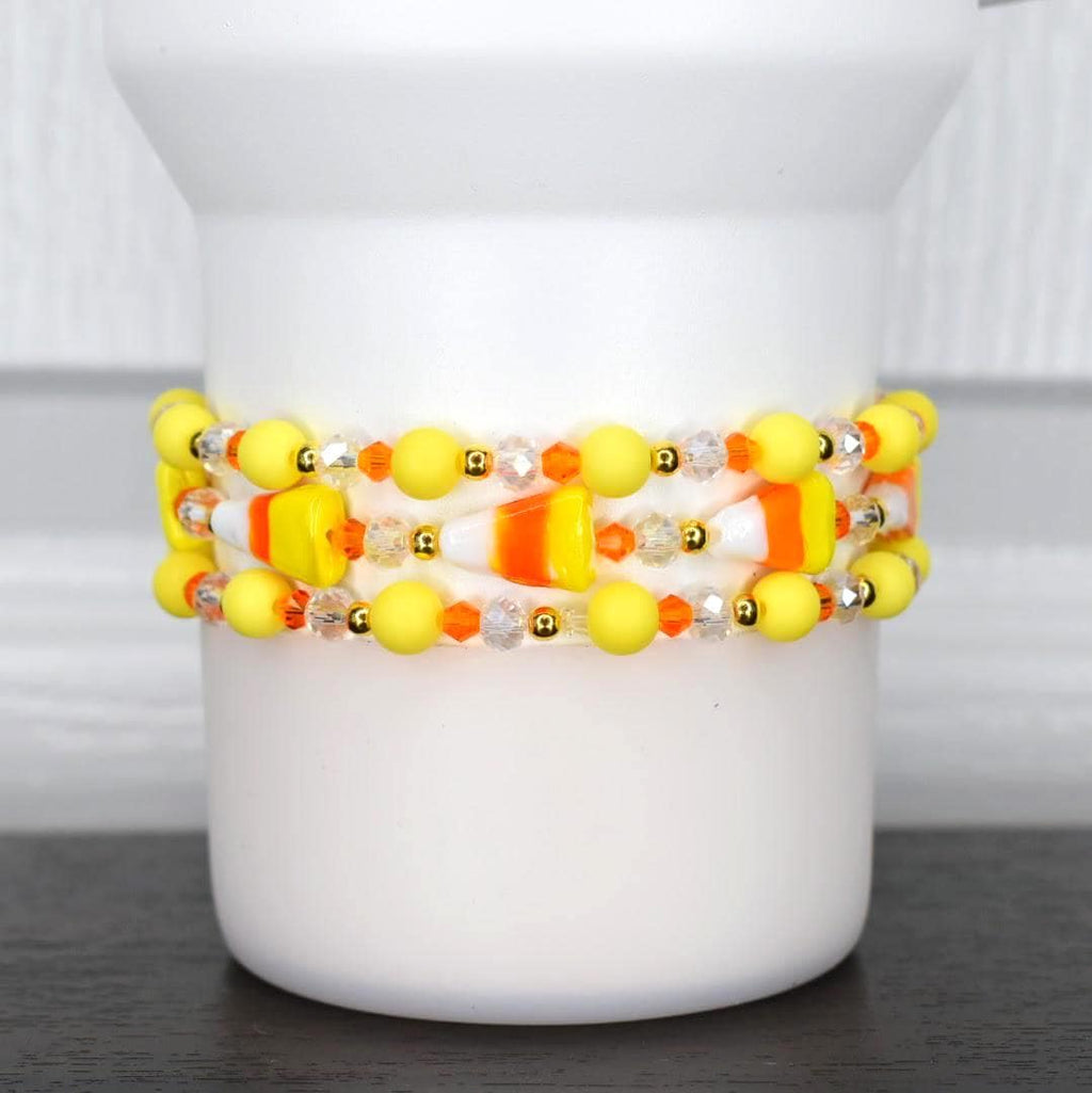 Halloween candy corn tumbler bracelet – yellow, orange, and white beaded wrap with candy corn charms for spooky drinkware accessories.