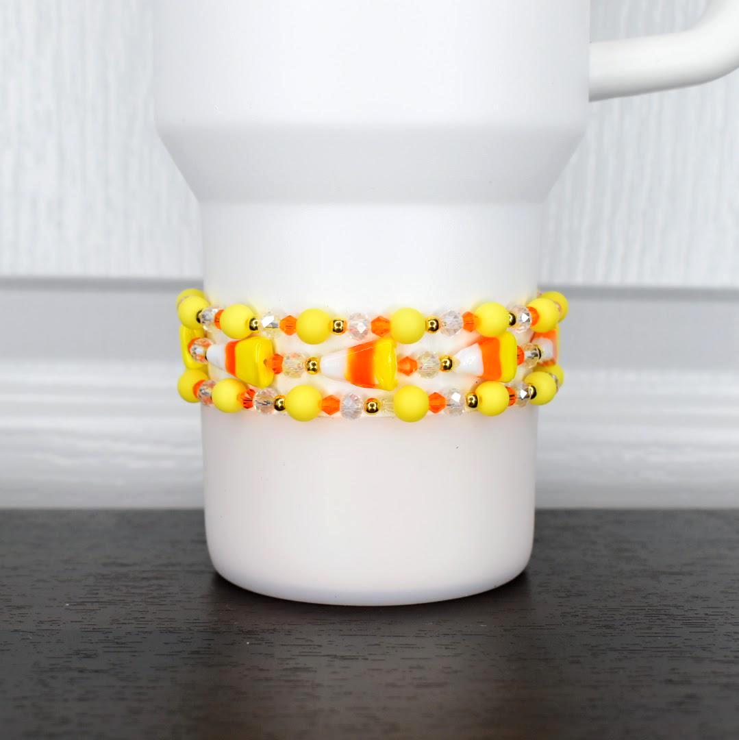 Candy corn bracelet – festive orange, yellow, and white beaded wrap for Halloween tumblers or wrist jewelry.