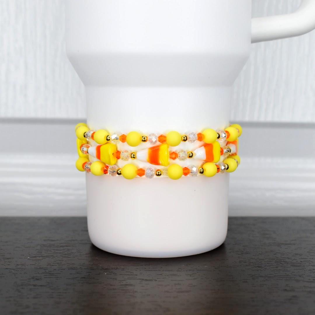Candy corn bracelet – festive orange, yellow, and white beaded wrap for Halloween tumblers or wrist jewelry.