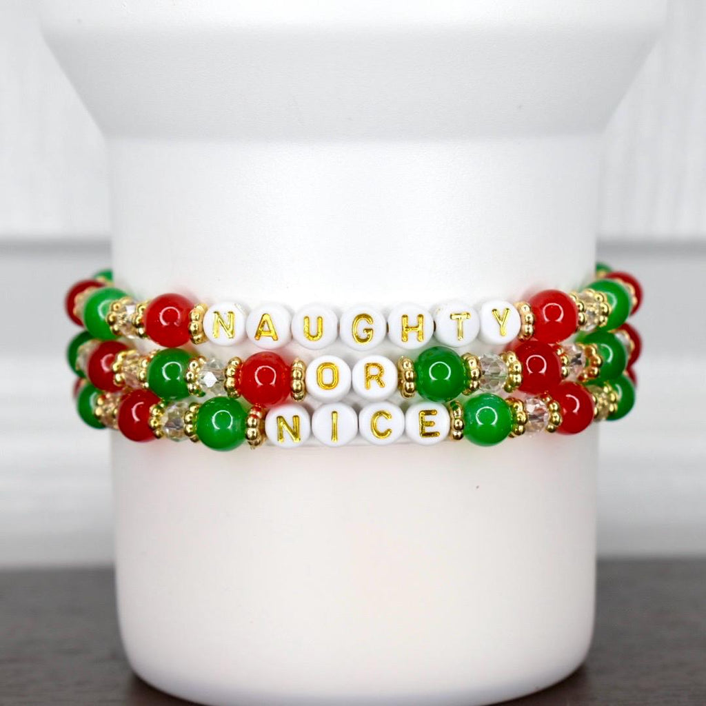 Set of three festive holiday bracelets featuring red, green, and gold beads with Naughty or Nice lettering, perfect for Christmas accessories.