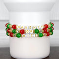 Set of three festive holiday bracelets featuring red, green, and gold beads with Naughty or Nice lettering, perfect for Christmas accessories.