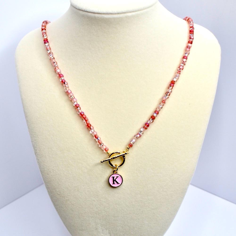 Beaded Necklace Jewelry Glass Bead Strand Pink Red White Color Palette Gold Toggle Clasp Design Round Letter Charm Pendant Personalized Jewelry Accessory Custom Initial Necklace Gift Collection