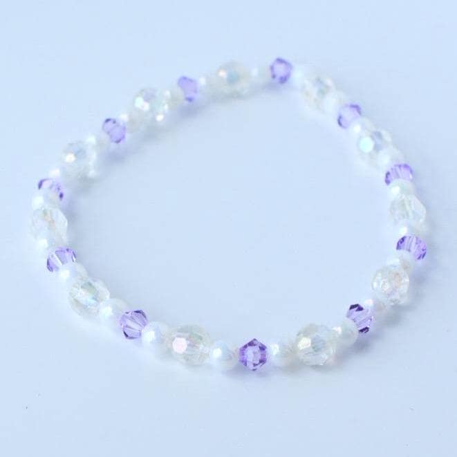 A delicate bracelet featuring a mix of iridescent and white beads, interspersed with small, faceted purple beads. The bracelet is strung together, creating a flexible and elegant accessory.