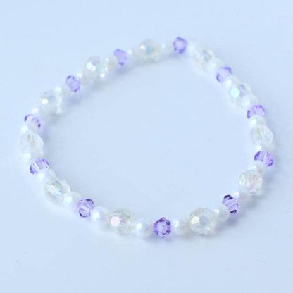 A delicate bracelet featuring a mix of iridescent and white beads, interspersed with small, faceted purple beads. The bracelet is strung together, creating a flexible and elegant accessory.