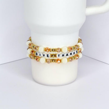 Give Thanks tumbler charm bracelet – gold and ivory beaded wrap for Thanksgiving and fall seasonal drinkware.