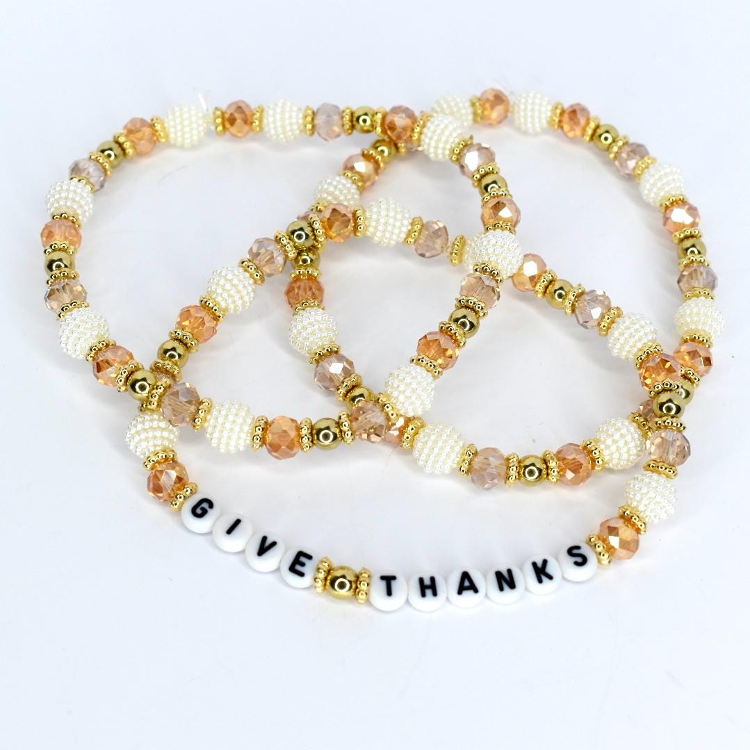 Thanksgiving hostess gift tumbler bracelet – ‘Give Thanks’ beaded wrap in gold and ivory for autumn drinkware accessories.