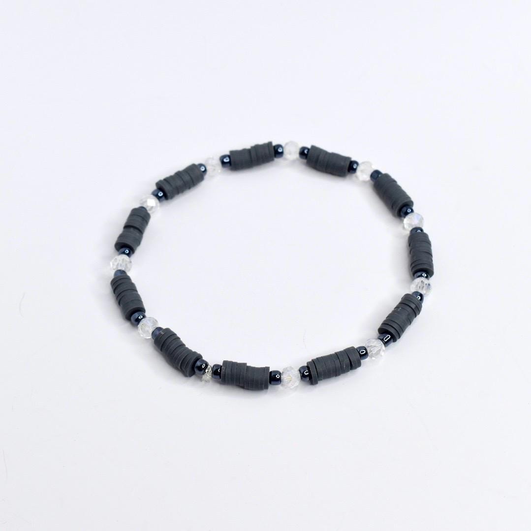 Handmade spooky tumbler bracelet stack – black and gray beads with spider web and skeleton charms for Halloween or gothic cup accessories.