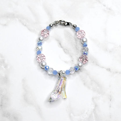 Children’s Disney Cinderella bracelet featuring holographic glass shoe pendant with periwinkle blue beads and silver pearl details - princess dress up accessory for girls
