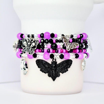 Gothic tumbler bracelet set with purple, black, and silver beads featuring skull, butterfly, bat, and moth charms – Halloween goth beaded wrap bracelet for tumblers and gothic cup accessories.
