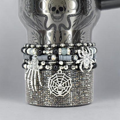 Halloween tumbler bracelet wrap with spider, skeleton hand, and spiderweb charms – gothic beaded drink accessory.