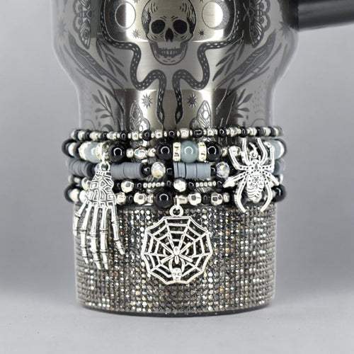 Halloween tumbler bracelet wrap with spider, skeleton hand, and spiderweb charms – gothic beaded drink accessory.