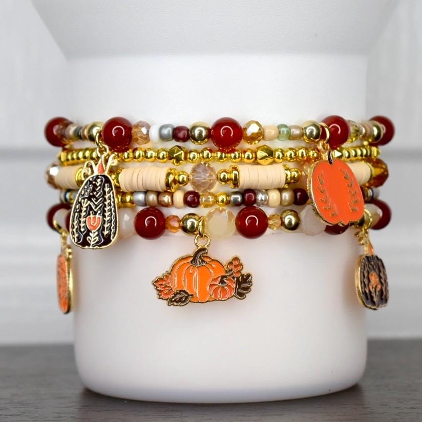 Thanksgiving hostess gift tumbler bracelet stack - handmade fall beaded wrap with pumpkin charms and autumn colors.